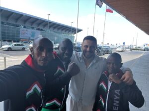 Four men pose for a photo at an Airport